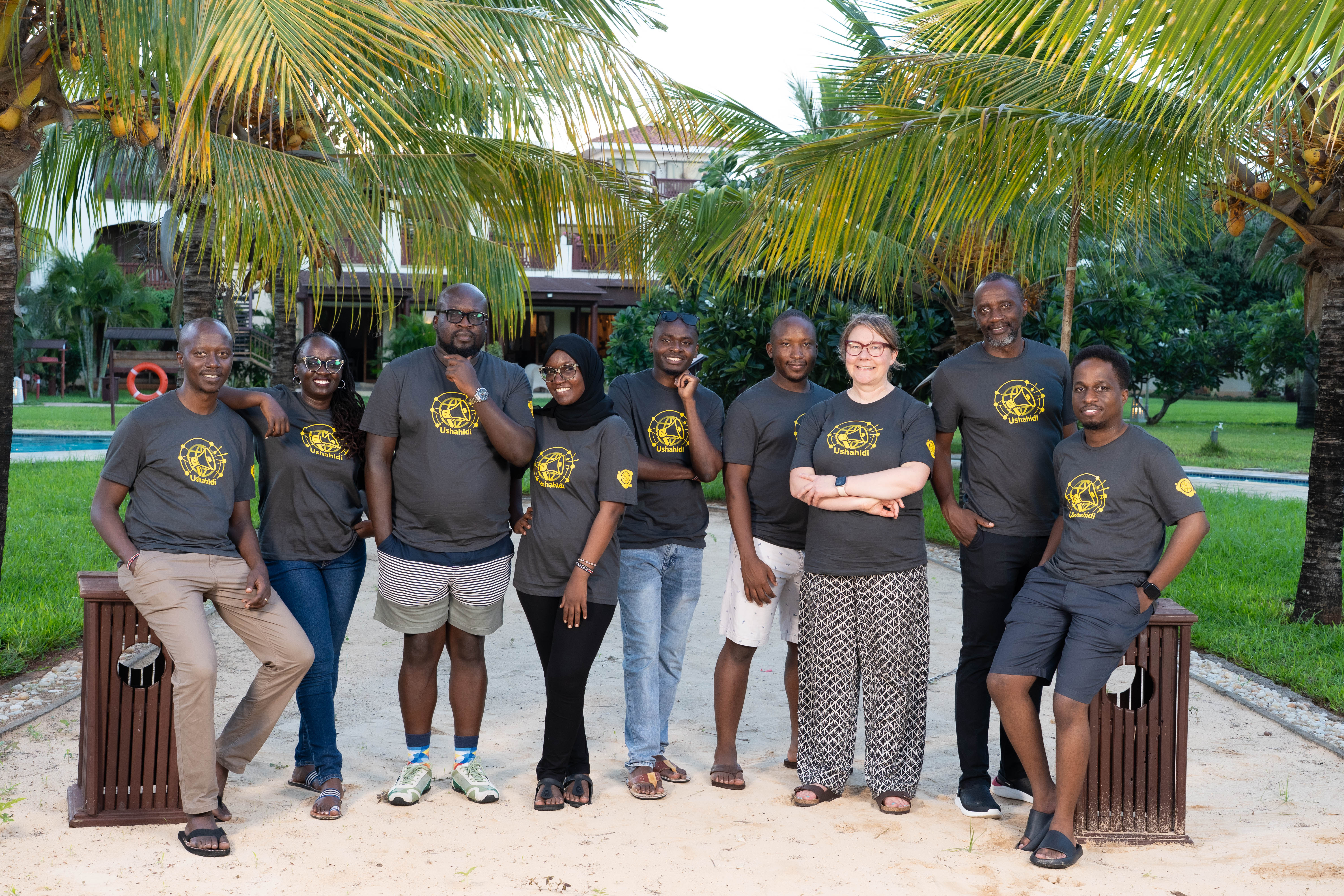 The team posing for a photo, wearing the Ushahidi t-shirts