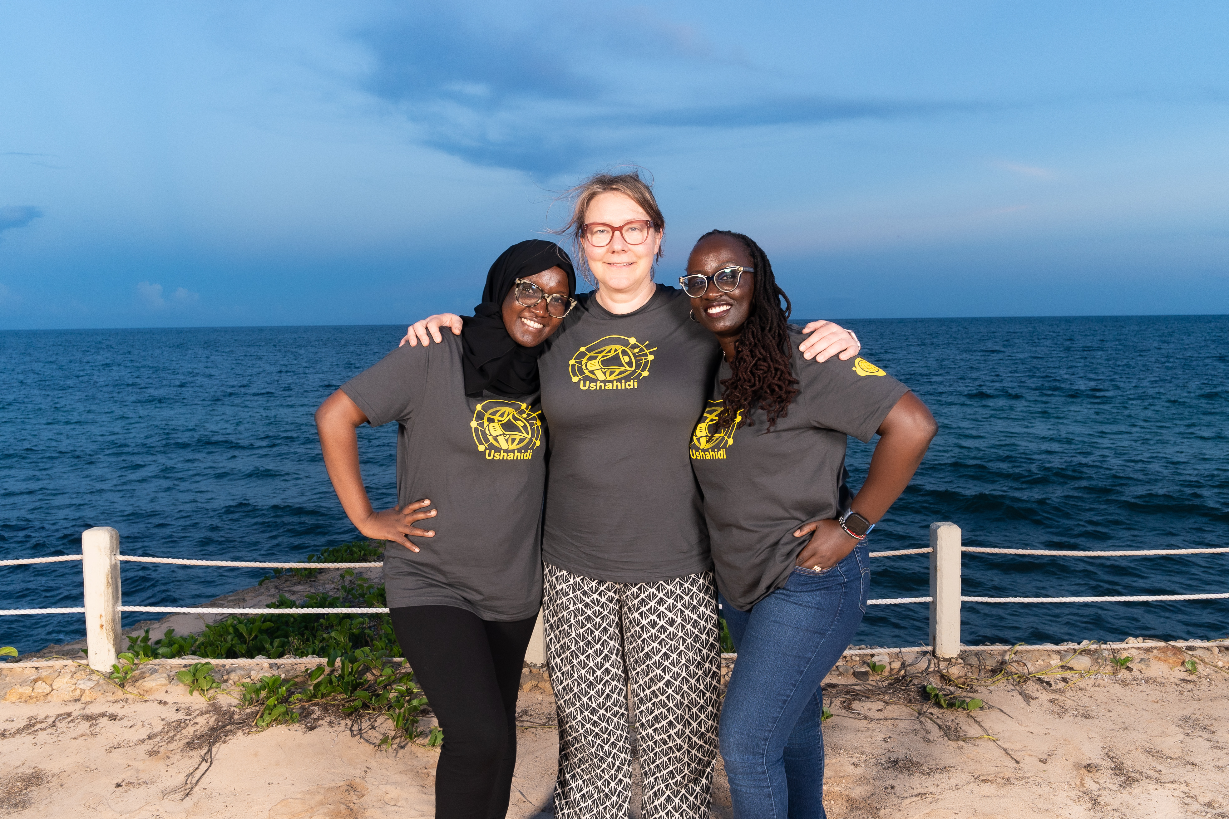 Female members of the Ushahidi team posing on steps